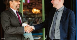 Two business partners shaking hands in agreement