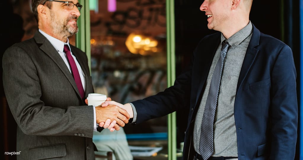 Two business partners shaking hands in agreement